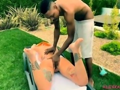 Black guy rubs oil and fucks a tattooed busty milf outside