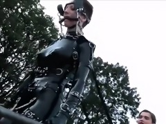 Latex freaks playing out kinky lesbian BDSM fantasy outdoors