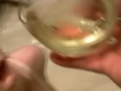Sexy brunette hottie drinks her pee from a glass