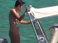 naked slim asian milf bathing and tanning on boat